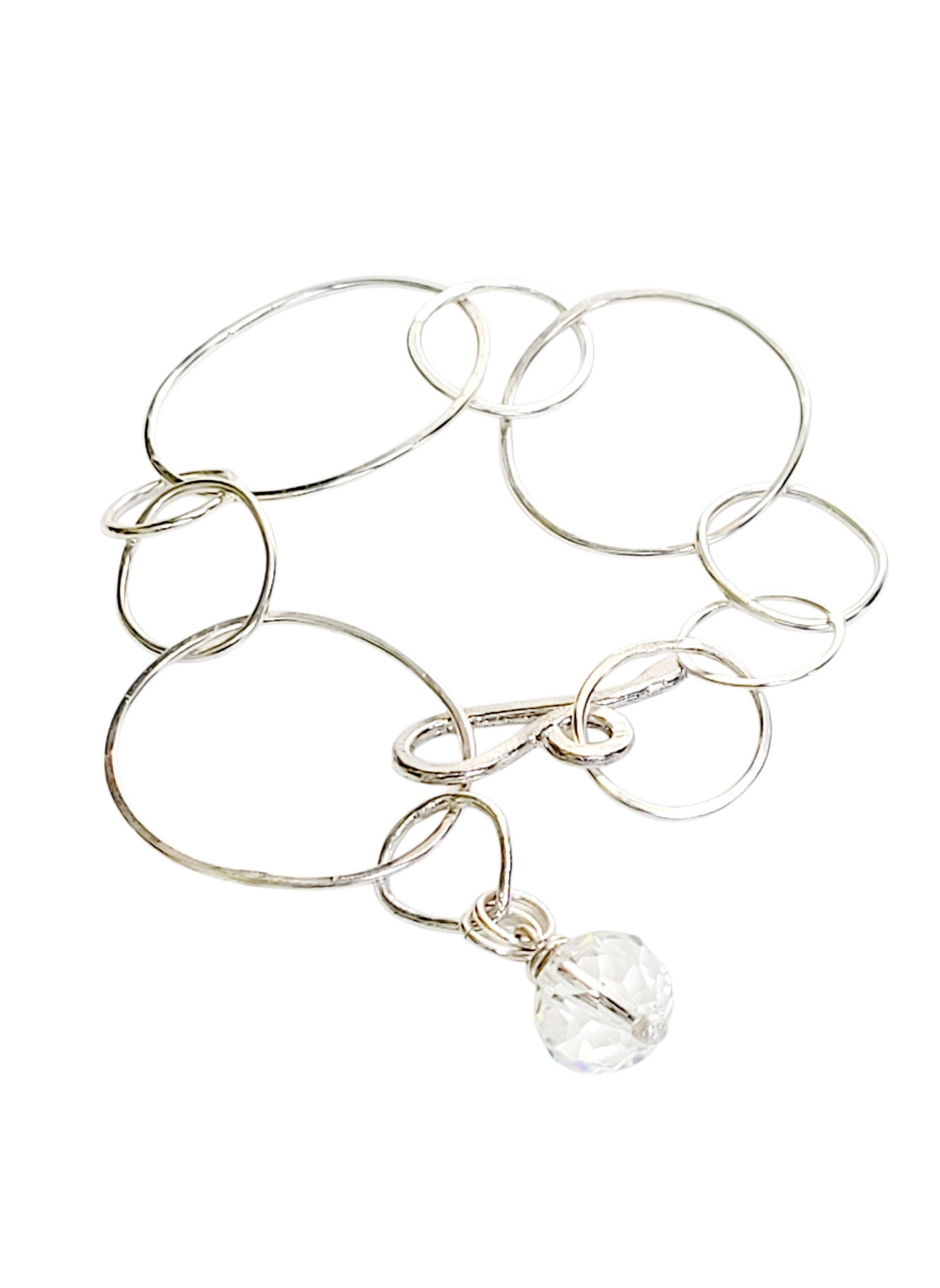 Sterling Silver bracelet features hammered rings.