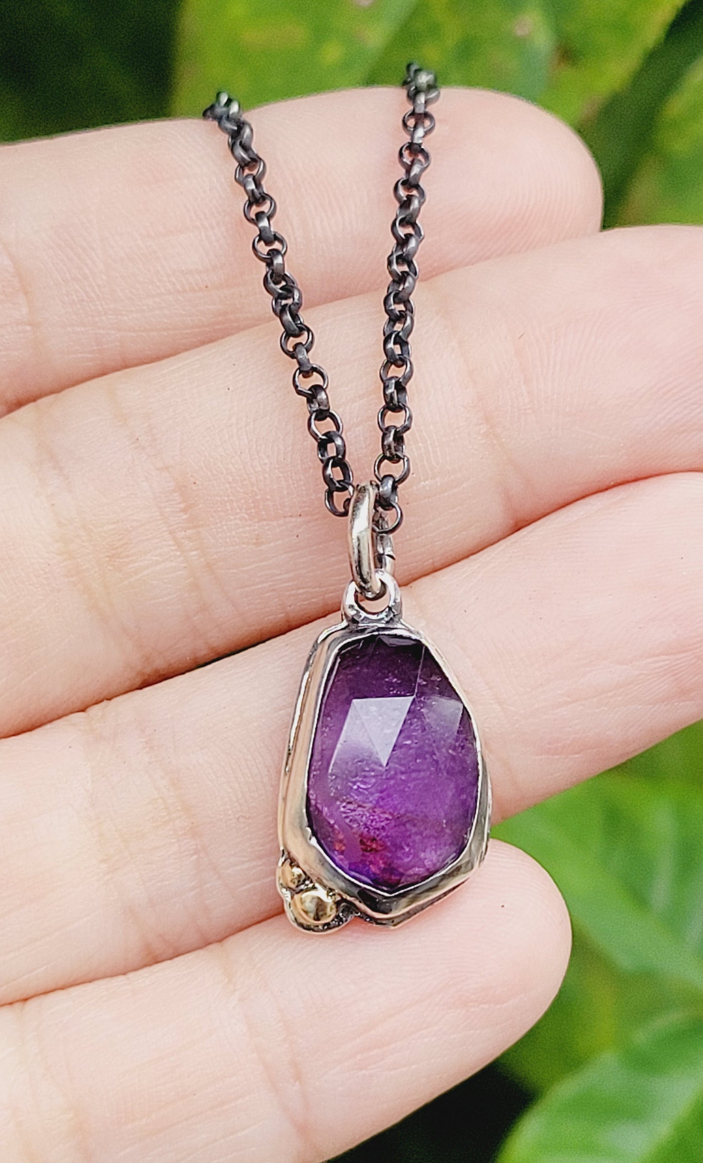 Pendant set amethyst in sterling silver with 14k gold details.