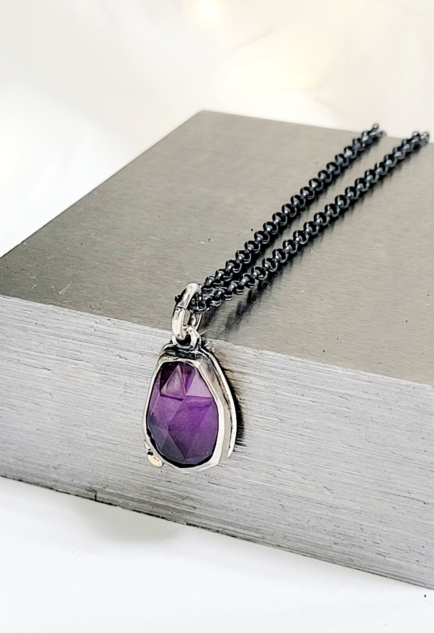 Pendant set amethyst in sterling silver with 14k gold details.