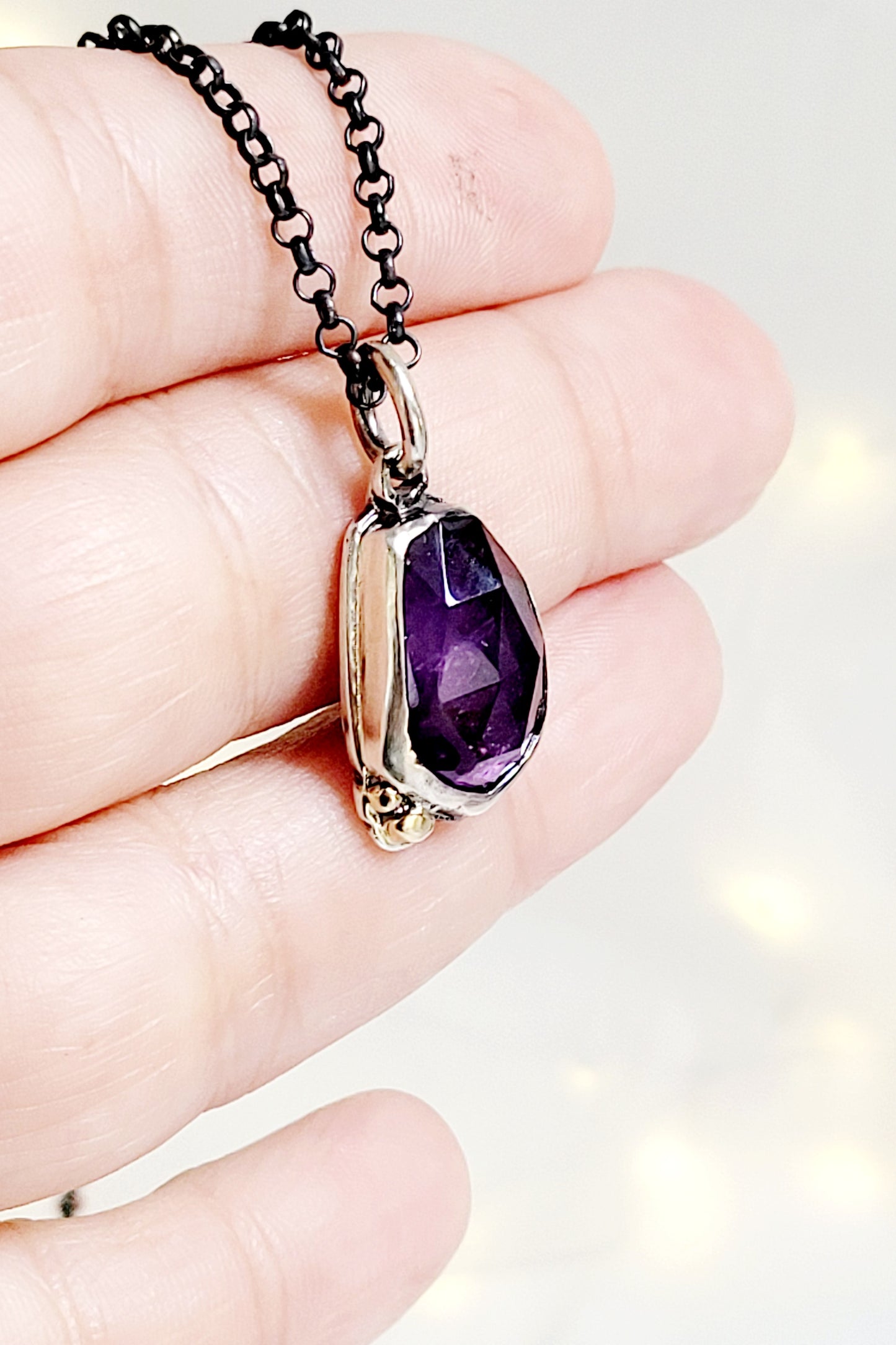 Pendant set amethyst in sterling silver with 14k gold details.