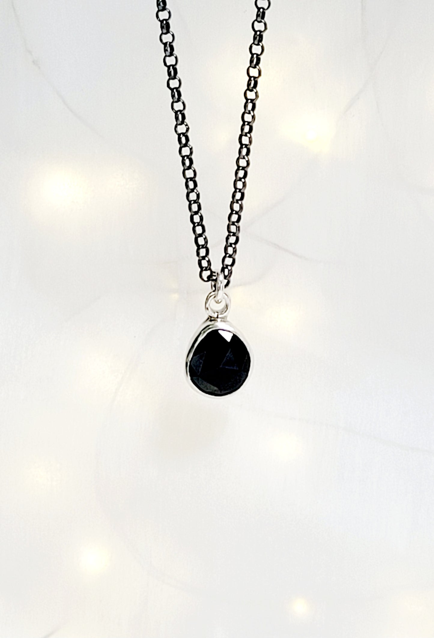 Minimalist pendant made of sterling silver and faceted onyx