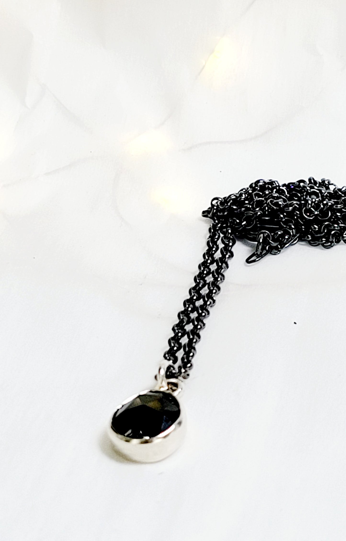 Minimalist pendant made of sterling silver and faceted onyx