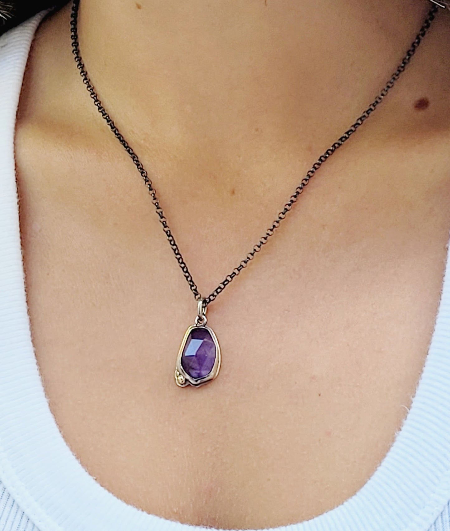Pendant set amethyst in sterling silver with 14k gold details.