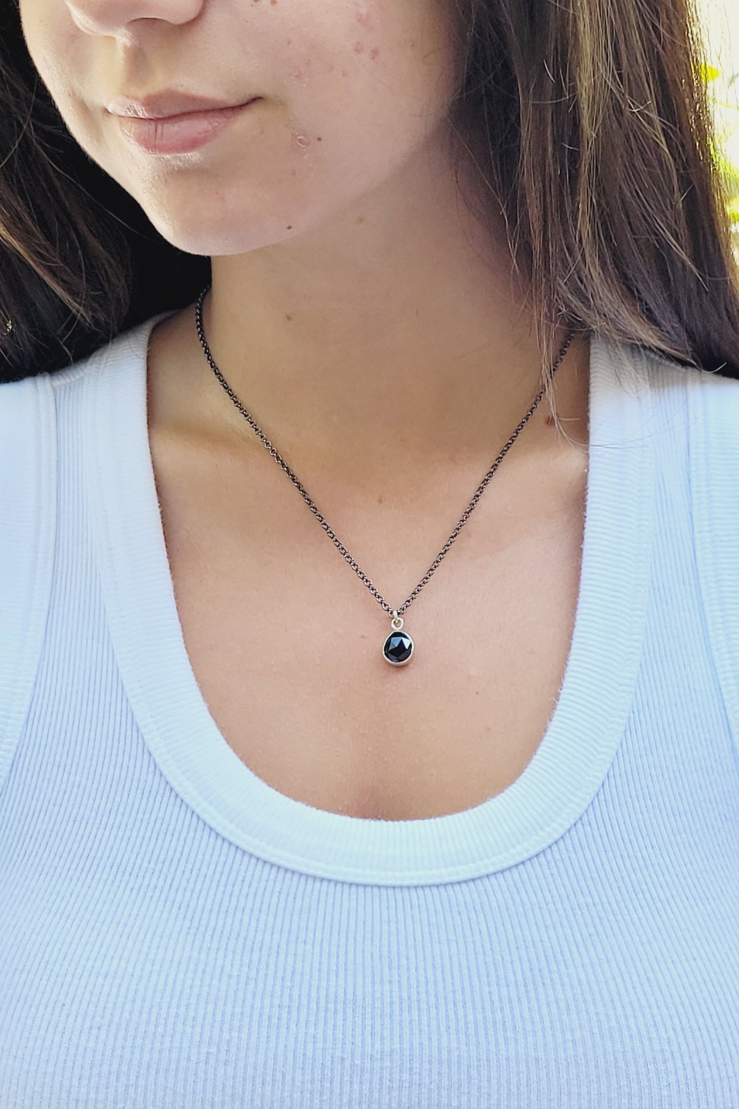 Minimalist pendant made of sterling silver and faceted onyx