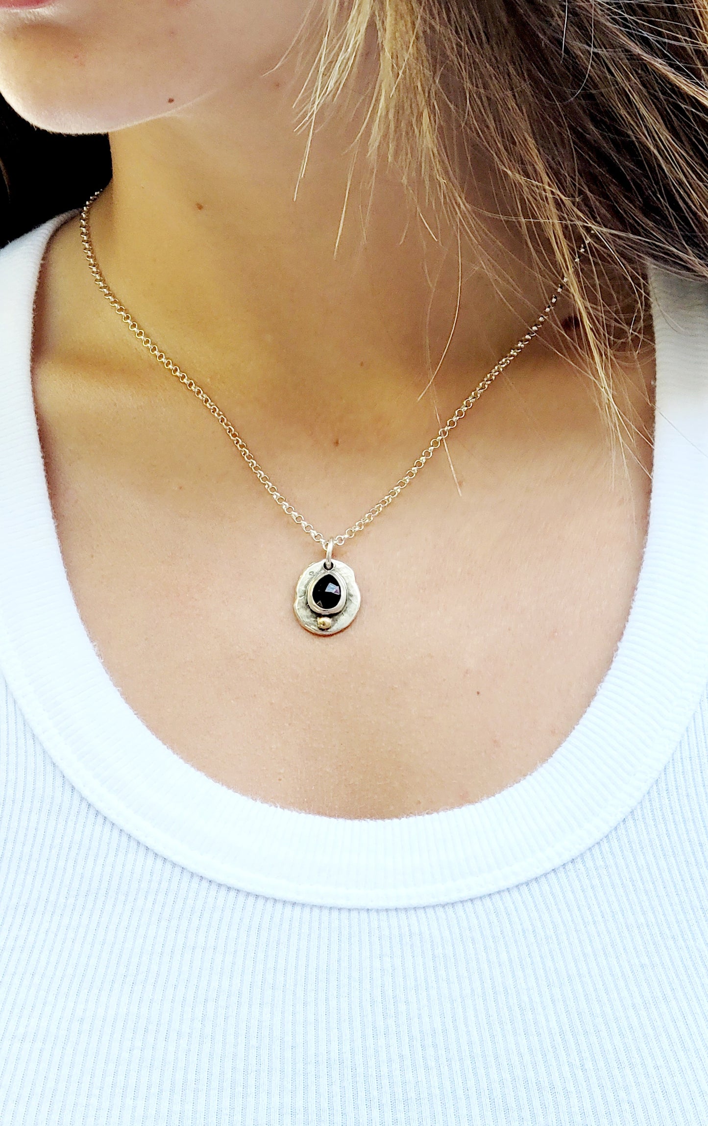 Handmade pendant in sterling silver with 14k gold detail and faceted onyx set