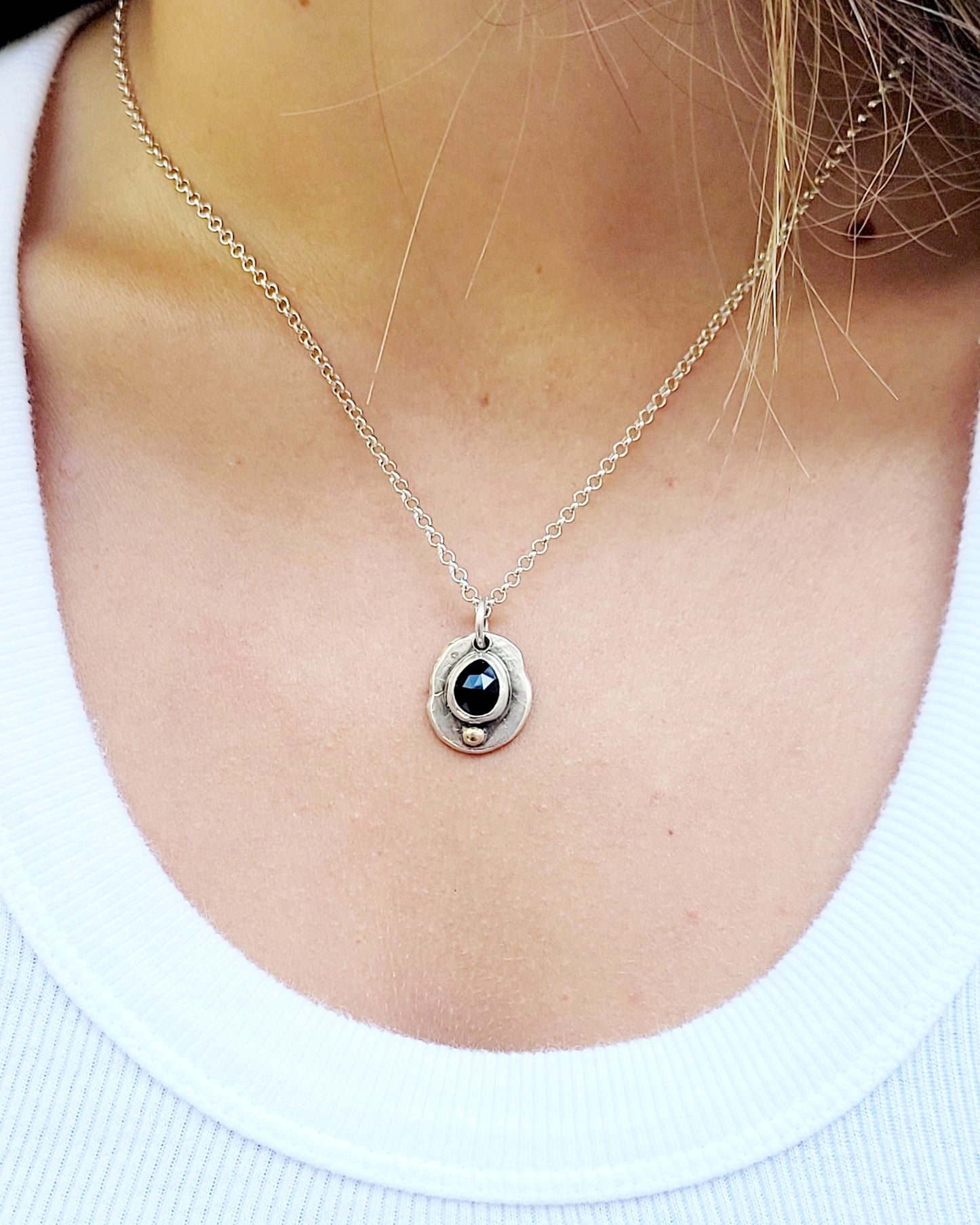 Handmade pendant in sterling silver with 14k gold detail and faceted onyx set