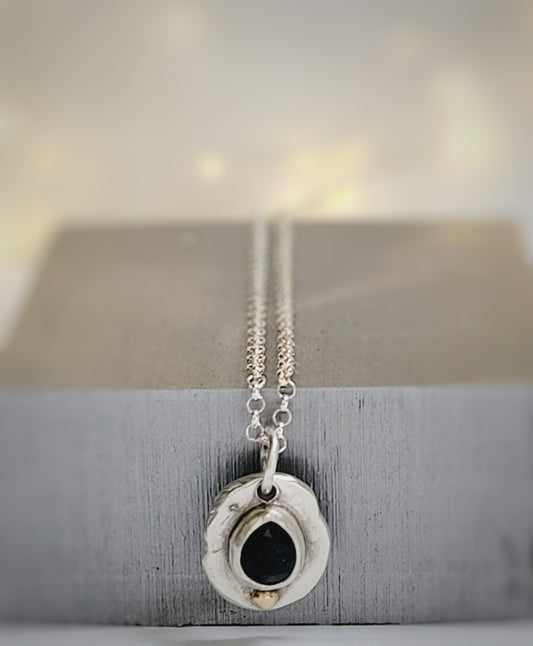 Handmade pendant in sterling silver with 14k gold detail and faceted onyx set