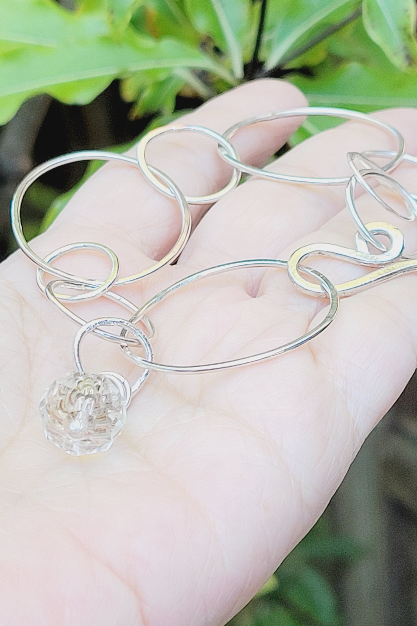 Sterling Silver bracelet features hammered rings.