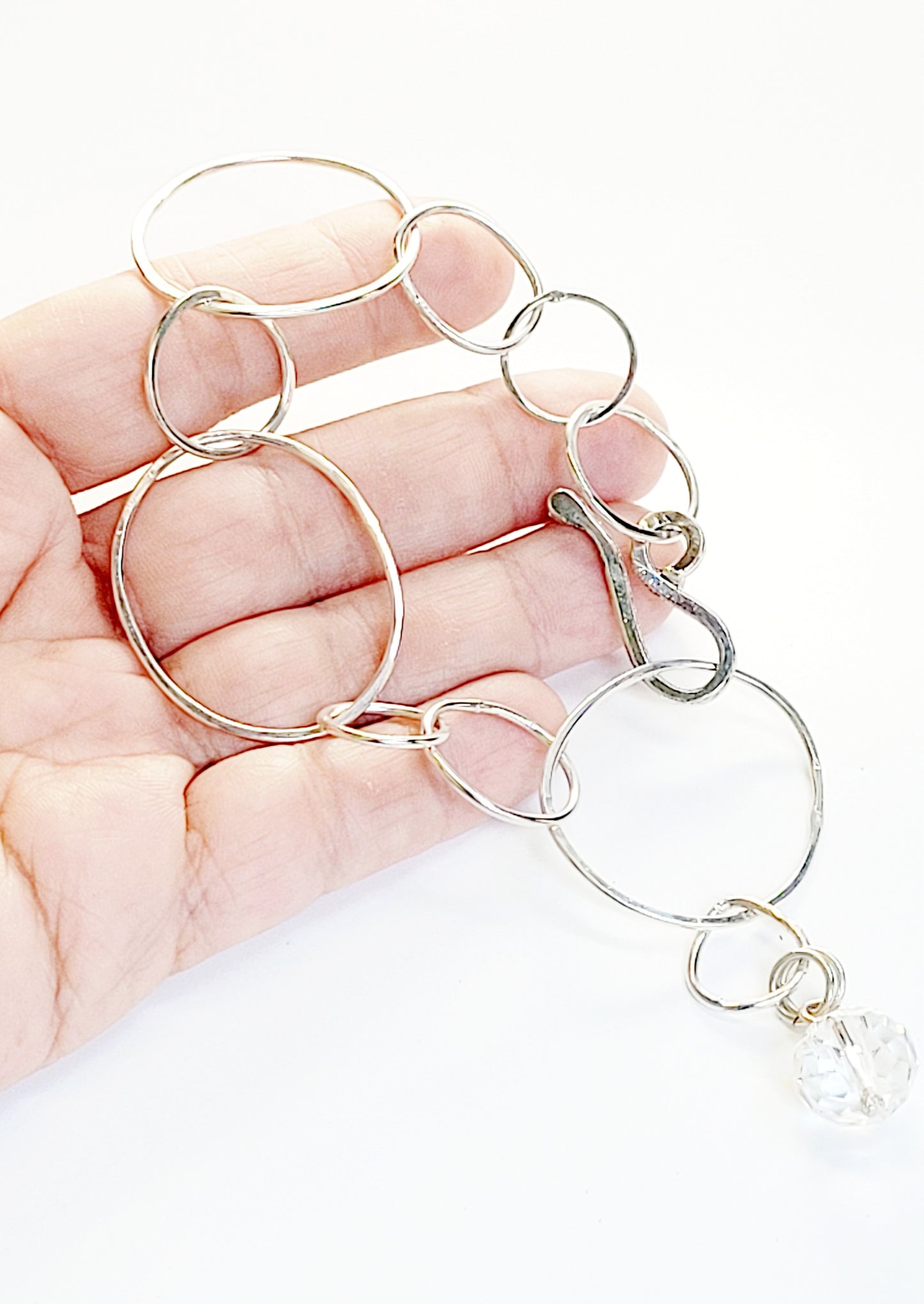 Sterling Silver bracelet features hammered rings.