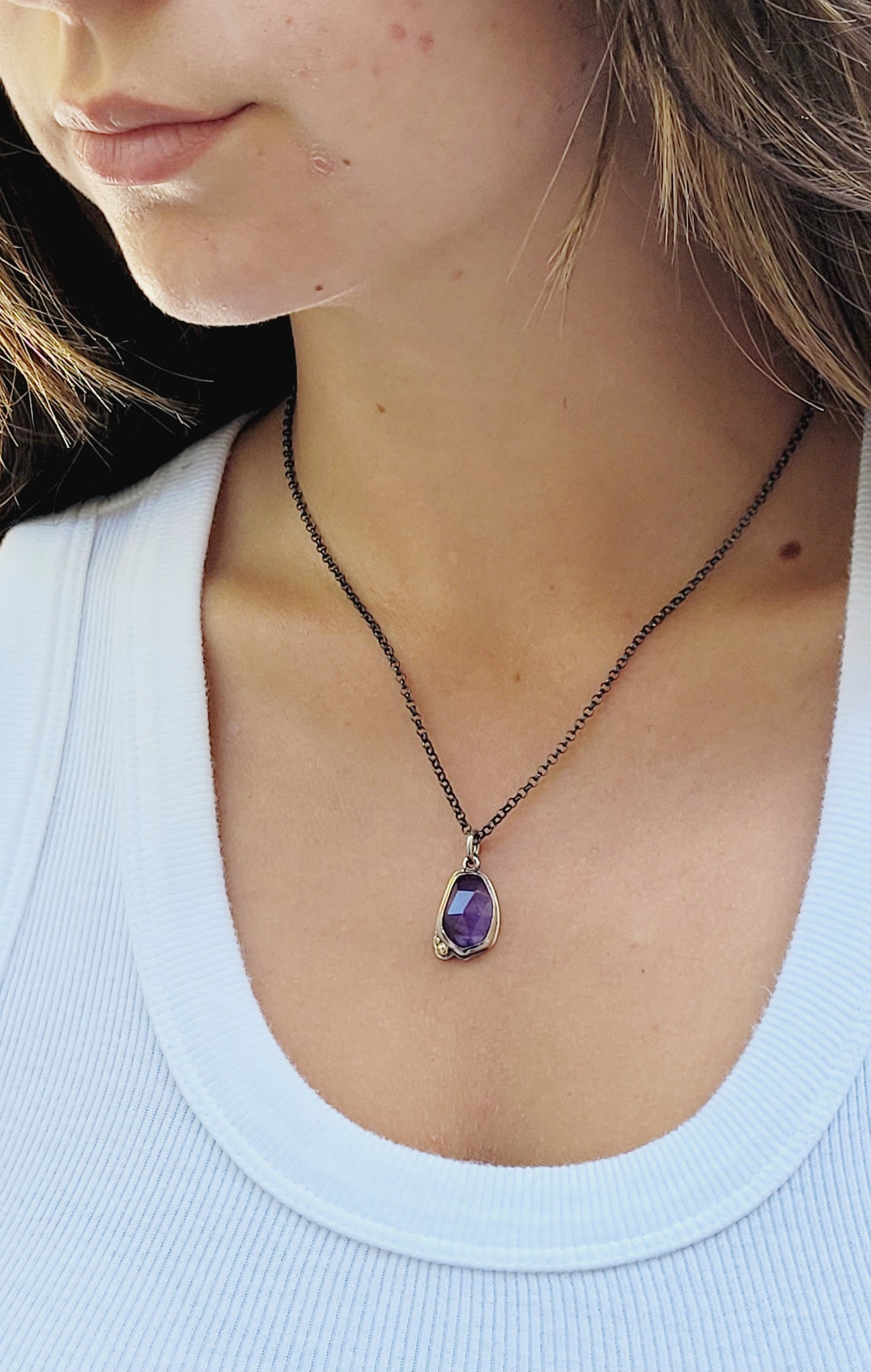 Pendant  set amethyst in sterling silver with 14k gold details.