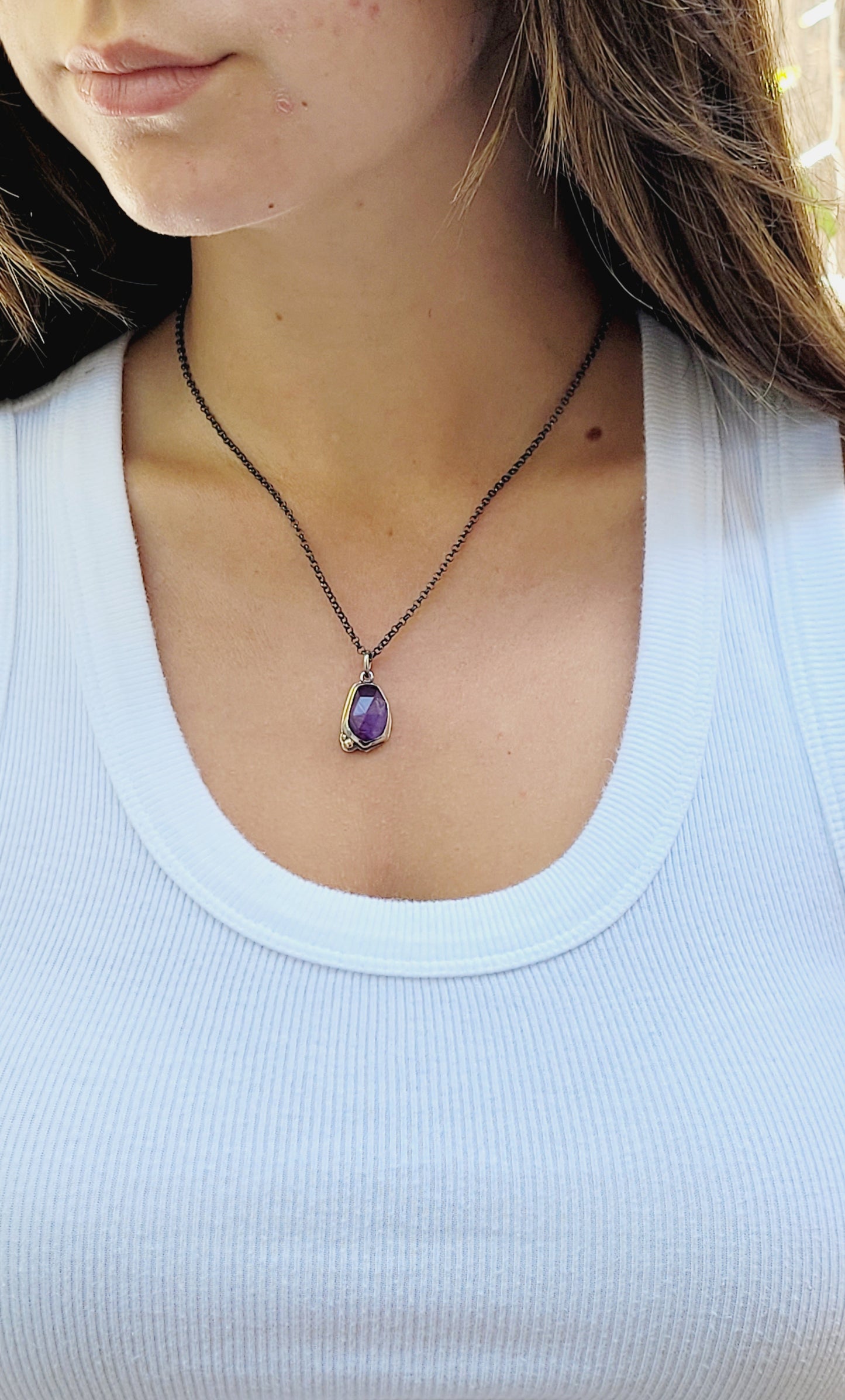 Pendant  set amethyst in sterling silver with 14k gold details.