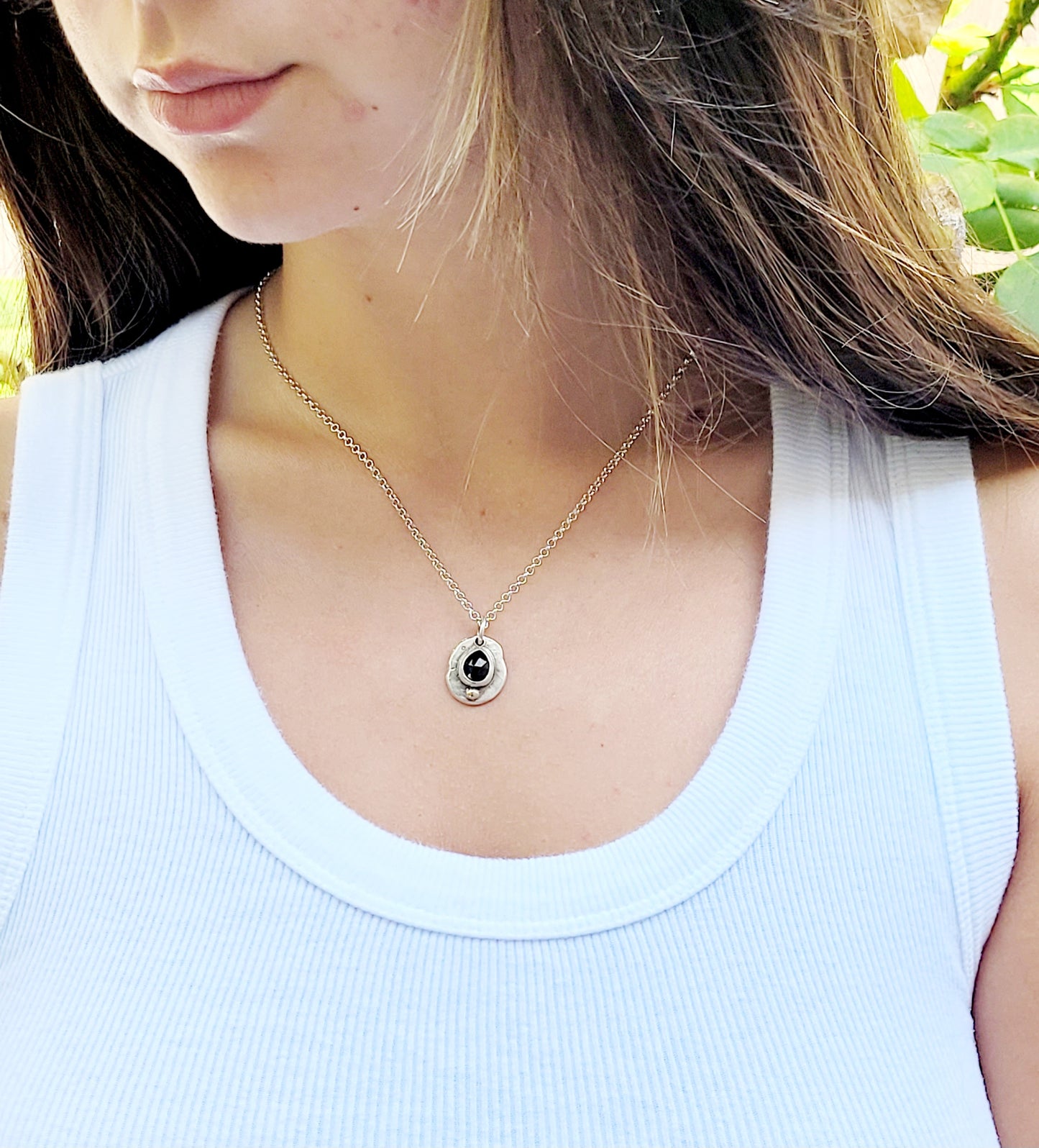 Handmade pendant in sterling silver with 14k gold detail and faceted onyx set